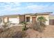 Home featuring a three-car garage, desert landscaping, and tiled roof at 3439 Cottage Canyon St, Laughlin, NV 89029