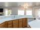 Bright kitchen featuring white countertops, a dual sink, and light wood cabinets with backyard view at 3439 Cottage Canyon St, Laughlin, NV 89029