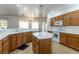 Modern kitchen with center island, white countertops, and stainless steel appliances at 3439 Cottage Canyon St, Laughlin, NV 89029