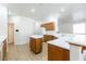 Open kitchen with white countertops, a central island, wood cabinets, and wood flooring at 3439 Cottage Canyon St, Laughlin, NV 89029