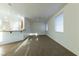 Bright, carpeted living room with a ceiling fan, recessed lighting, and a view of the kitchen at 3439 Cottage Canyon St, Laughlin, NV 89029