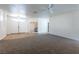 Spacious open-concept living room with new carpet and wood-look flooring at 3439 Cottage Canyon St, Laughlin, NV 89029