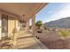 Inviting covered patio with seating area and views of the desert-landscaped backyard and mountains at 3439 Cottage Canyon St, Laughlin, NV 89029