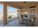 Covered patio with a dining area, grill, and views of the desert landscape at 3439 Cottage Canyon St, Laughlin, NV 89029