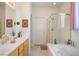 Bright bathroom featuring a double vanity, soaking tub, and glass-enclosed shower at 3491 Cottage Thistle Dr, Laughlin, NV 89029