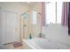 Relaxing bathroom featuring a separate shower and soaking tub under a bright window at 3491 Cottage Thistle Dr, Laughlin, NV 89029