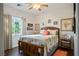 Inviting bedroom with a wood-framed bed, bright windows, and charming coastal-themed decor at 3491 Cottage Thistle Dr, Laughlin, NV 89029