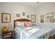 Comfortable bedroom featuring a wooden headboard, decorative pillows, and nautical-themed wall art at 3491 Cottage Thistle Dr, Laughlin, NV 89029