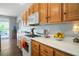 Charming kitchen with oak cabinets, white countertops, and stainless steel gas range and view of the outdoor patio at 3491 Cottage Thistle Dr, Laughlin, NV 89029