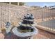 Outdoor three-tiered water fountain and desert landscape at 3491 Cottage Thistle Dr, Laughlin, NV 89029