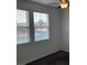 Bright bedroom with a ceiling fan, two windows, and brown carpet at 3530 E Moffat Ave, Pahrump, NV 89061