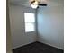 Small bedroom has a ceiling fan, one window, and carpet at 3530 E Moffat Ave, Pahrump, NV 89061