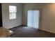 Open living space with window and sliding glass door for natural light, and plush carpet at 3530 E Moffat Ave, Pahrump, NV 89061
