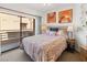 Brightly lit bedroom featuring a large window to a balcony, ceiling fan and modern decor at 3843 Desert Marina Dr # 232, Laughlin, NV 89029