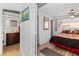 Bedroom with a bathroom view featuring a cozy bed, wood floors, and natural light from the window at 3843 Desert Marina Dr # 232, Laughlin, NV 89029