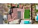 Overhead view of a home with a red tile roof, solar panels, a green lawn, and a sparkling pool at 4108 Freel Peak Ct, Las Vegas, NV 89129