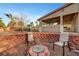 Cozy backyard featuring a custom fire pit with two chairs and an open patio at 4108 Freel Peak Ct, Las Vegas, NV 89129