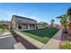This home features a large, manicured lawn, covered patio, and lush landscaping for outdoor enjoyment at 4108 Freel Peak Ct, Las Vegas, NV 89129