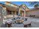 Spacious backyard patio with a fountain, curved benches, and outdoor seating area at 4108 Freel Peak Ct, Las Vegas, NV 89129