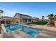 Beautiful backyard with a pool, spa, covered patio, and lush green lawn for outdoor enjoyment at 4108 Freel Peak Ct, Las Vegas, NV 89129