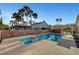 A relaxing backyard with pool, spa, gazebo, and covered patio amidst tropical palm trees at 4108 Freel Peak Ct, Las Vegas, NV 89129