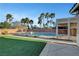A sparkling pool and spa are surrounded by lush landscaping and palm trees in the backyard at 4108 Freel Peak Ct, Las Vegas, NV 89129