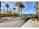 Gated entrance featuring festive holiday wreaths and palm trees lining the drive at 4108 Freel Peak Ct, Las Vegas, NV 89129