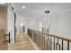 Hallway with hardwood floors, railing and modern lighting fixture at 4108 Freel Peak Ct, Las Vegas, NV 89129