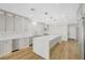 Spacious kitchen featuring a large island with white countertops and modern lighting at 4108 Freel Peak Ct, Las Vegas, NV 89129