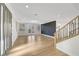 Stunning living area with modern floors, staircase, designer wall and natural light through French doors at 4108 Freel Peak Ct, Las Vegas, NV 89129