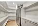 Large walk-in pantry with ample shelving and storage space, featuring a stainless fridge at 4108 Freel Peak Ct, Las Vegas, NV 89129