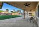 Spacious covered patio with seating overlooking a lush lawn, pool, and well-manicured backyard at 4108 Freel Peak Ct, Las Vegas, NV 89129