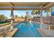 Relax in this backyard pool and spa, featuring a covered patio with a ceiling fan for outdoor comfort at 4108 Freel Peak Ct, Las Vegas, NV 89129