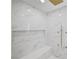 Detailed shot of the glass shower with bench and rain shower head at 4108 Freel Peak Ct, Las Vegas, NV 89129