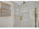 Modern glass shower with rainfall shower head, built-in niche, and gold hardware at 4108 Freel Peak Ct, Las Vegas, NV 89129