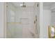 Luxurious shower featuring a rainfall shower head, seating, and gold fixtures at 4108 Freel Peak Ct, Las Vegas, NV 89129