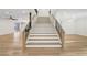 Elegant staircase featuring wood floors and white risers, leading to the upper level at 4108 Freel Peak Ct, Las Vegas, NV 89129
