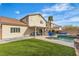 Spacious backyard features a pristine lawn, covered patio, pool with spa, and lush landscaping at 4247 Jordanville St, Las Vegas, NV 89129