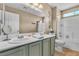 Bathroom with a double-sink vanity, large mirror, and shower-tub combination at 4247 Jordanville St, Las Vegas, NV 89129