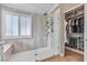 Modern walk-in shower featuring sleek fixtures, a built-in seat and a window for natural light at 4247 Jordanville St, Las Vegas, NV 89129