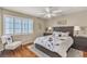 Bedroom with hardwood floors, ceiling fan, and a beautifully patterned bedspread at 4247 Jordanville St, Las Vegas, NV 89129