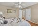 Bedroom with hardwood floors, ceiling fan, and an adjoining bathroom at 4247 Jordanville St, Las Vegas, NV 89129