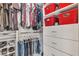 This closet features multiple shelves and hanging areas, plus red storage bins for extra organization at 4247 Jordanville St, Las Vegas, NV 89129