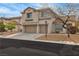 Charming two-story home with a two-car garage and a well-manicured front yard and a neutral colored exterior at 4247 Jordanville St, Las Vegas, NV 89129