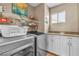 Well-organized laundry room with modern washer and dryer, ample shelving, and bright cabinets at 4247 Jordanville St, Las Vegas, NV 89129