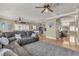 Spacious living area showcasing tile floors, an over-sized couch, and an open floor plan at 4247 Jordanville St, Las Vegas, NV 89129