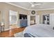 Inviting main bedroom with hardwood floors, a ceiling fan, and access to an en-suite bathroom at 4247 Jordanville St, Las Vegas, NV 89129