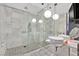 A well lit bathroom featuring marble tile, dual sinks, and glass enclosed shower at 4381 W Flamingo Rd # 1609, Las Vegas, NV 89103