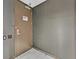 Image of a drab entryway door with neutral-toned walls and white tiled floor at 4381 W Flamingo Rd # 1609, Las Vegas, NV 89103