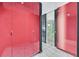 Hallway with bright red cabinets, light marble floors and glass doors at 4381 W Flamingo Rd # 1609, Las Vegas, NV 89103